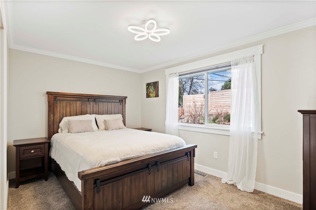 10404 Northeast 197th Street Bothell, WA 98011 - Photo 17 of 29 a bedroom with a bed and a window