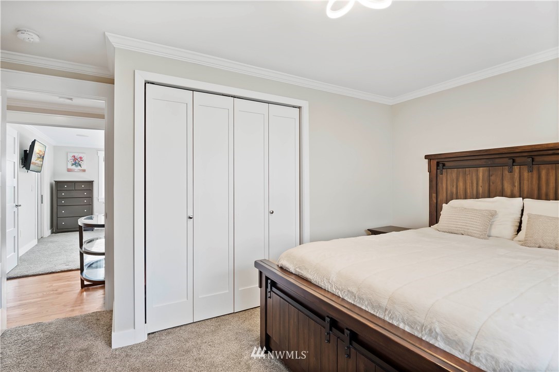 10404 Northeast 197th Street Bothell, WA 98011 - Photo 18 of 29 a bedroom with a bed and a view of en suite bathroom