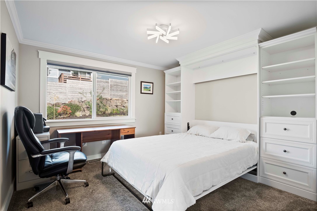 10404 Northeast 197th Street Bothell, WA 98011 - Photo 20 of 29 a bedroom with a large bed and a window