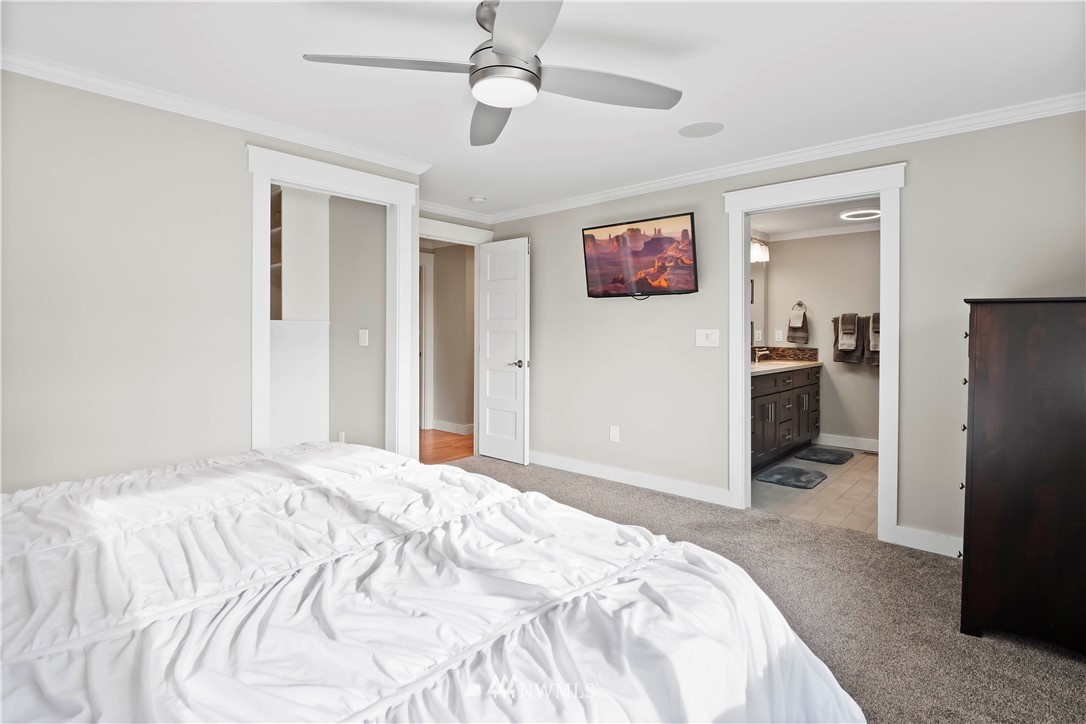 10404 Northeast 197th Street Bothell, WA 98011 - Photo 23 of 29 a bedroom with a bed and a chandelier