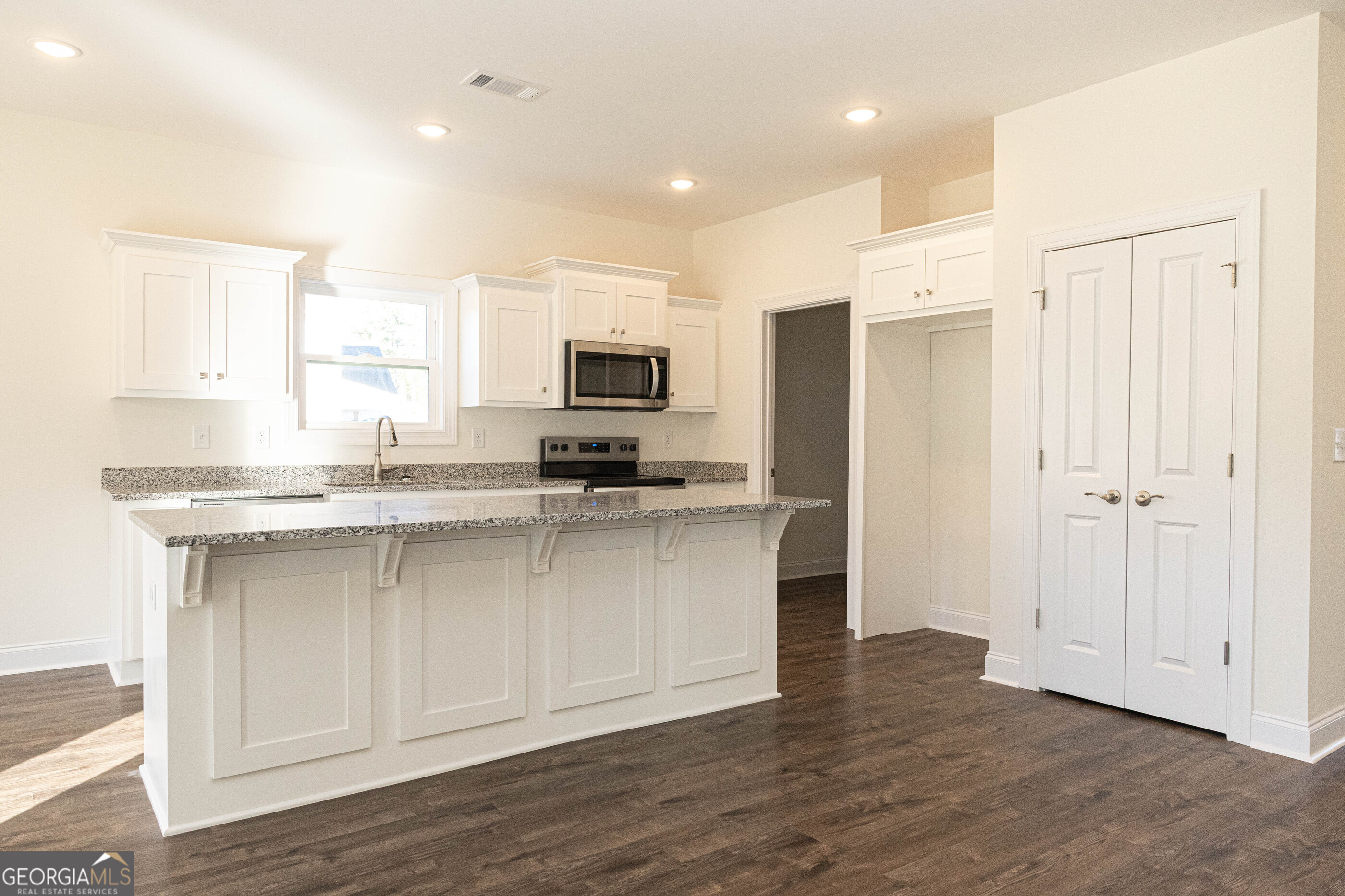 705 Riverside Estates Lanett, AL 36863 - Photo 8 of 29 a kitchen with kitchen island granite countertop a sink cabinets and stainless steel appliances