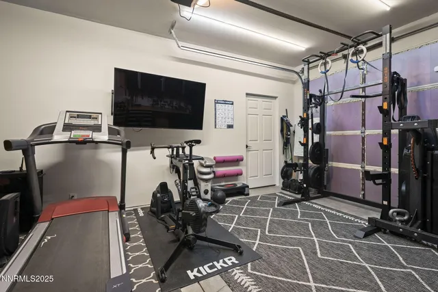 a room with gym equipment and a flat screen tv