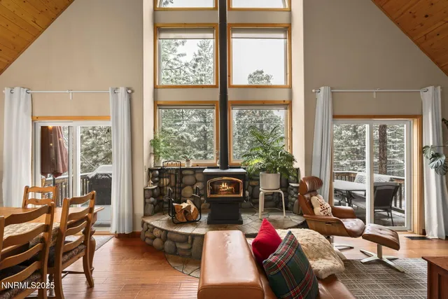 a living room with furniture and a floor to ceiling window