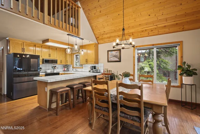 a large kitchen with a table and chairs