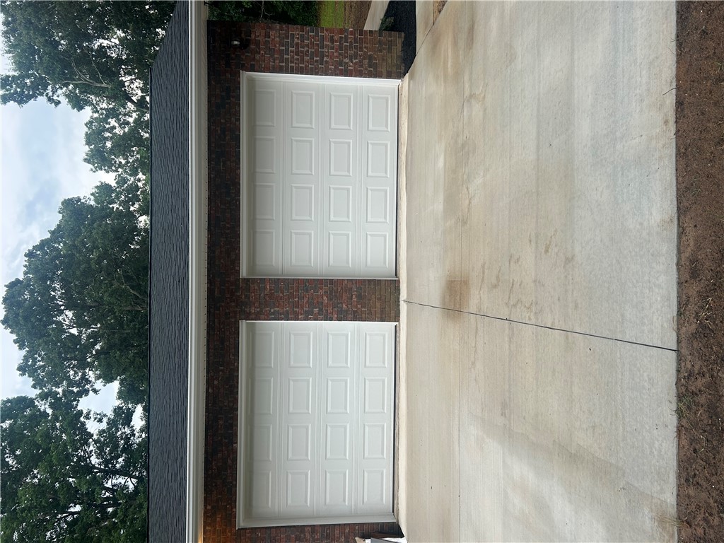 809 Paige Road Honea Path, SC 29654 - Photo 27 of 27 A robust brick exterior highlights the ample two-car garage with pristine white doors.