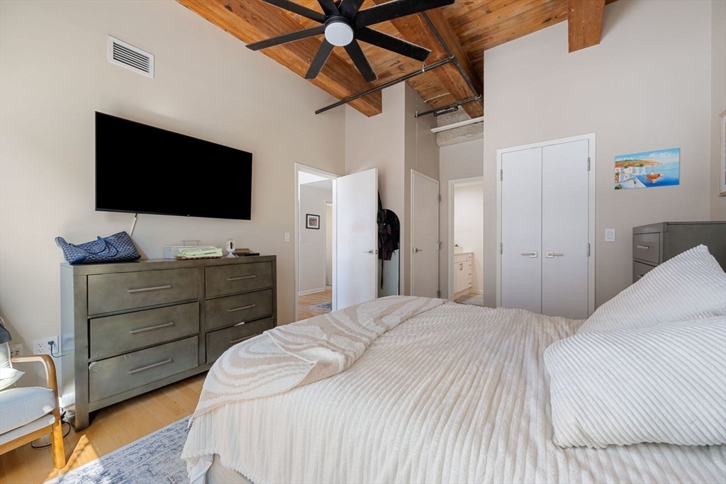 9 West Broadway, Unit 314 Boston, MA 02127 - Photo 15 of 25 a bedroom with a bed and a flat screen tv