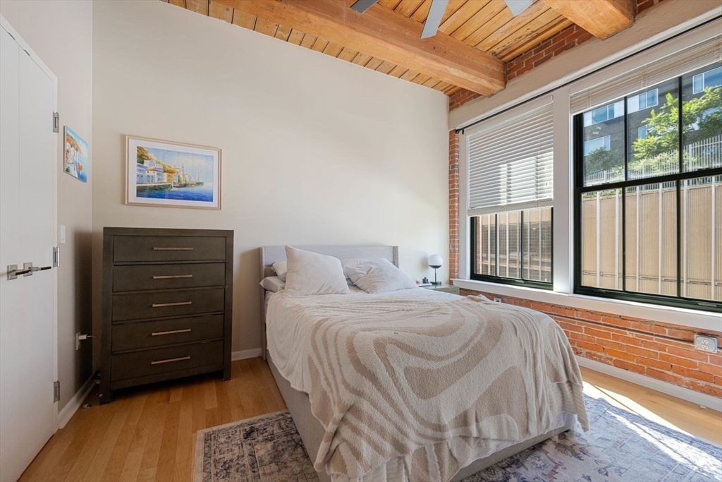 9 West Broadway, Unit 314 Boston, MA 02127 - Photo 18 of 25 a bedroom with a bed and a dresser