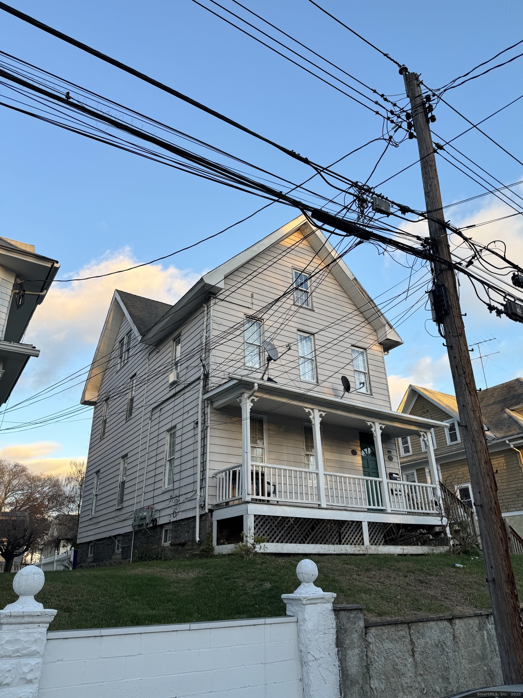 184 Pacific Street Bridgeport, CT 06604 - Photo 2 of 4 a front view of a house with a yard