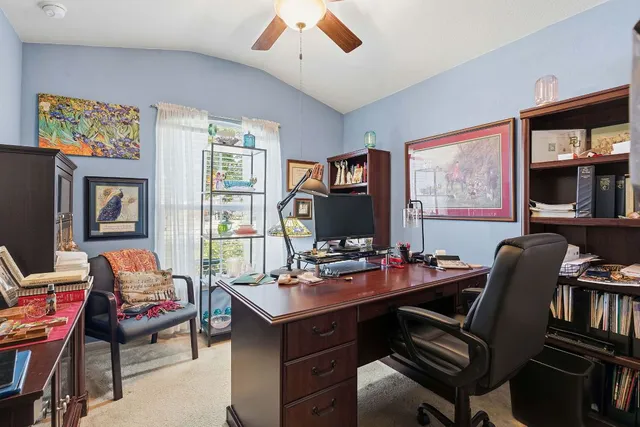 a view of a dining room with furniture a chandelier and window