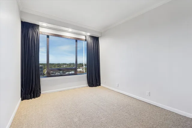a view of a big room with windows and city view