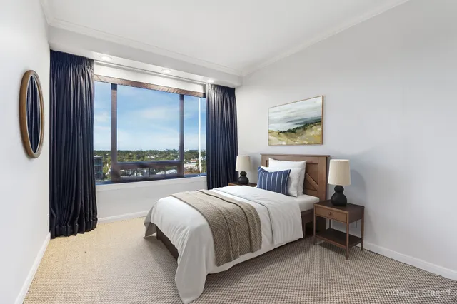 a bedroom with a large bed and a large window