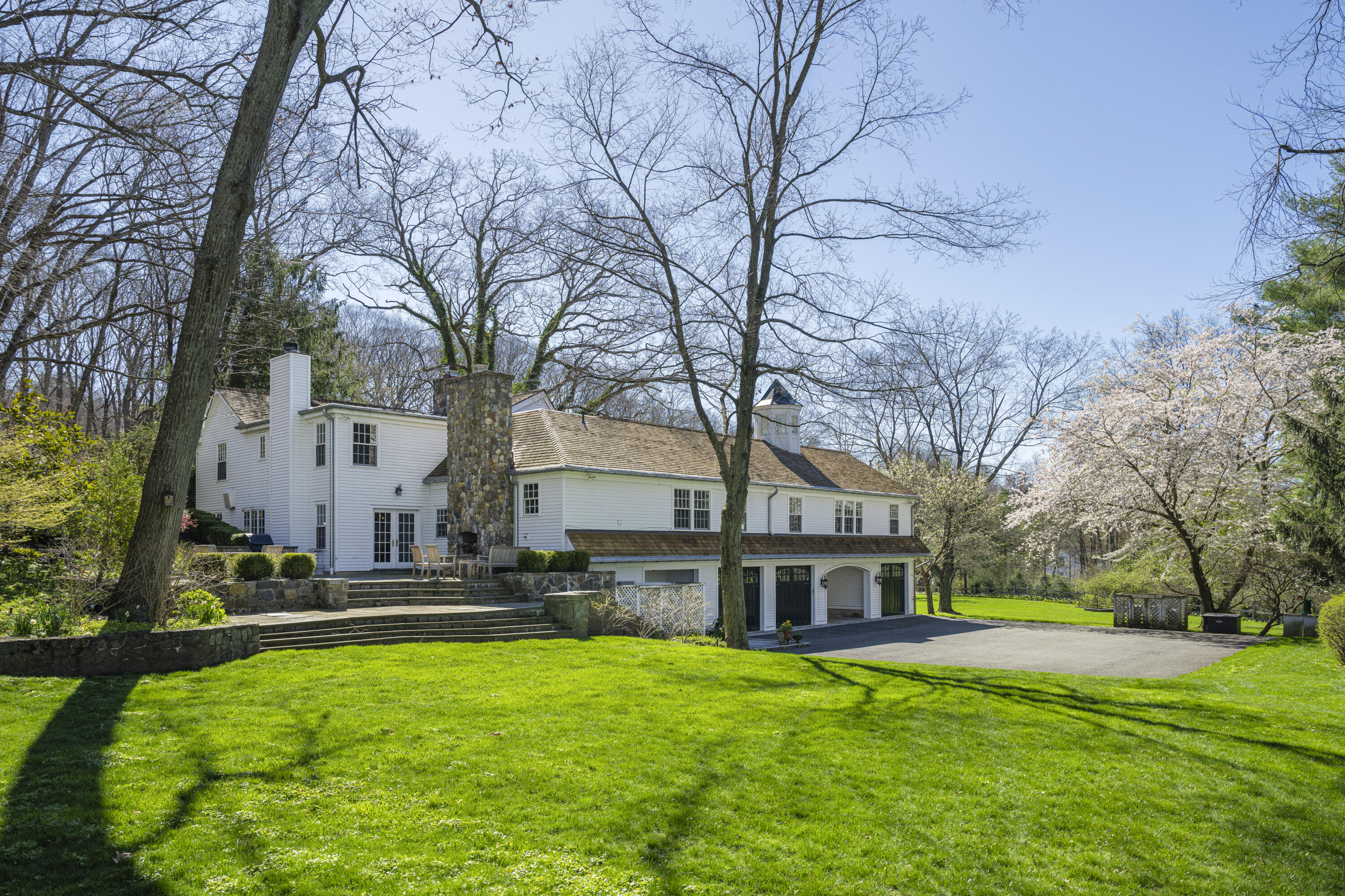 1446 Ponus Ridge Road New Canaan, CT 06840 - Photo 24 of 25 a view of a house with a big yard and large trees