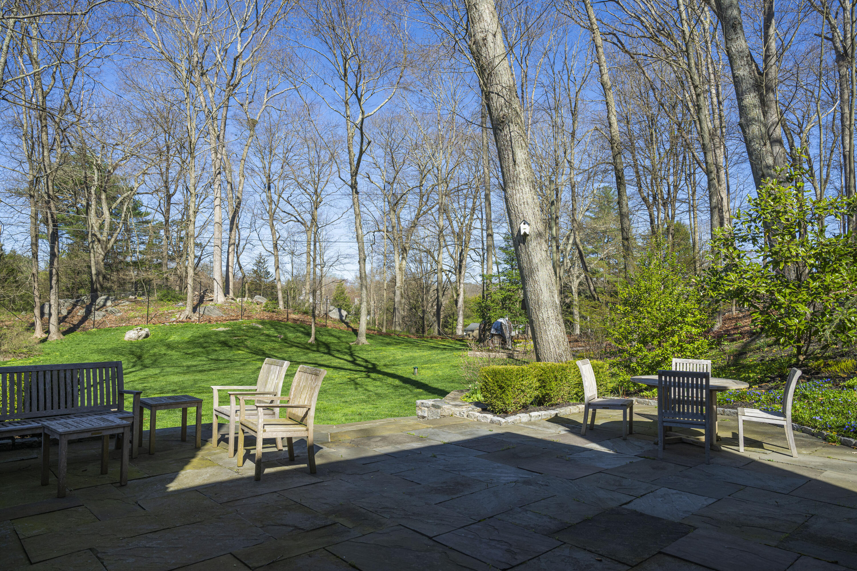1446 Ponus Ridge Road New Canaan, CT 06840 - Photo 25 of 25 a view of a chair and table in backyard of the house