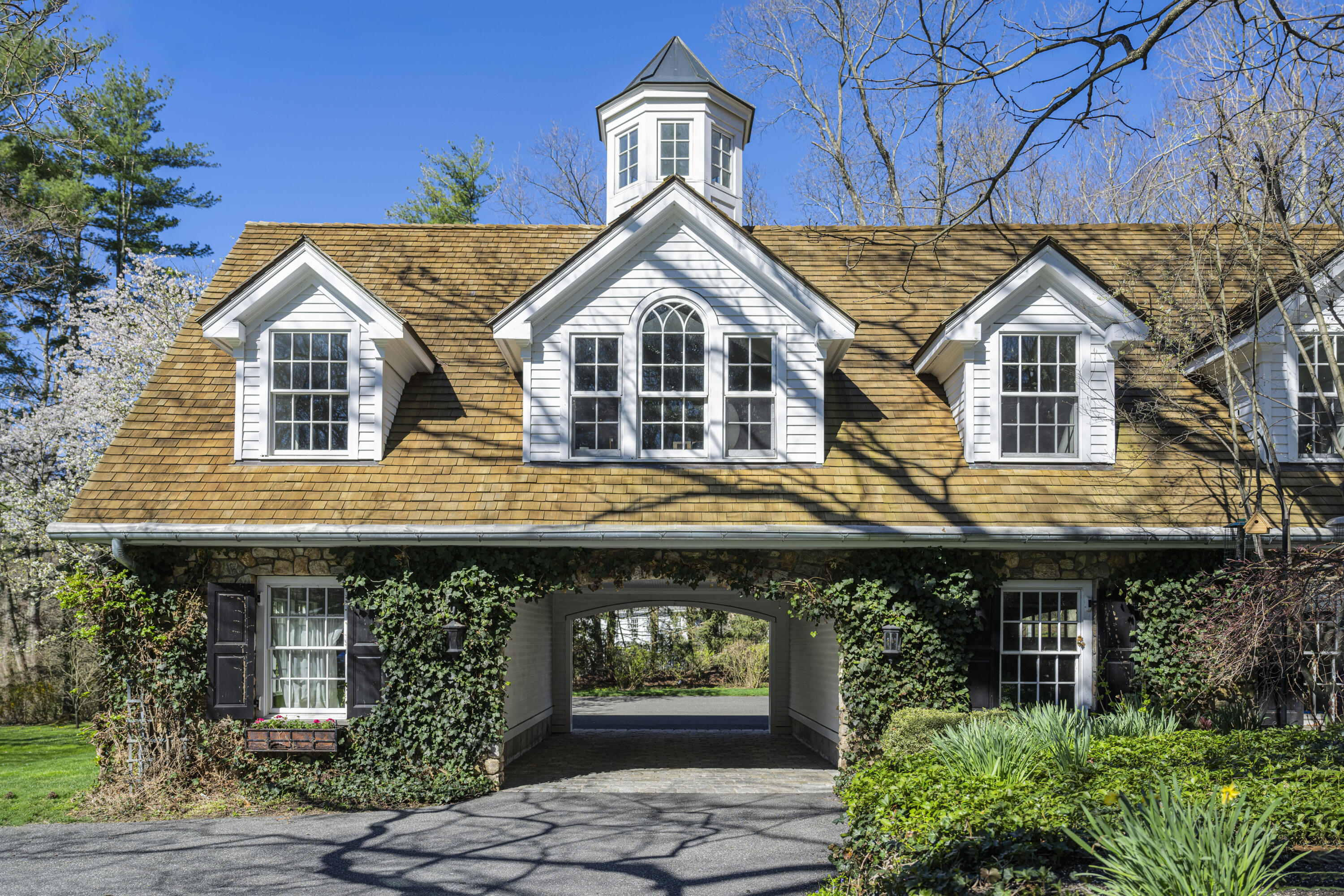 1446 Ponus Ridge Road New Canaan, CT 06840 - Photo 3 of 25 a front view of a house with garden