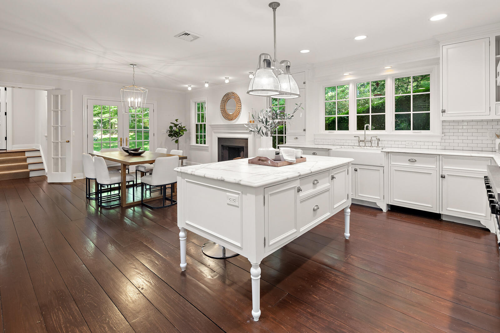 1446 Ponus Ridge Road New Canaan, CT 06840 - Photo 4 of 25 a large white kitchen with granite countertop a stove a sink a couch and a large window