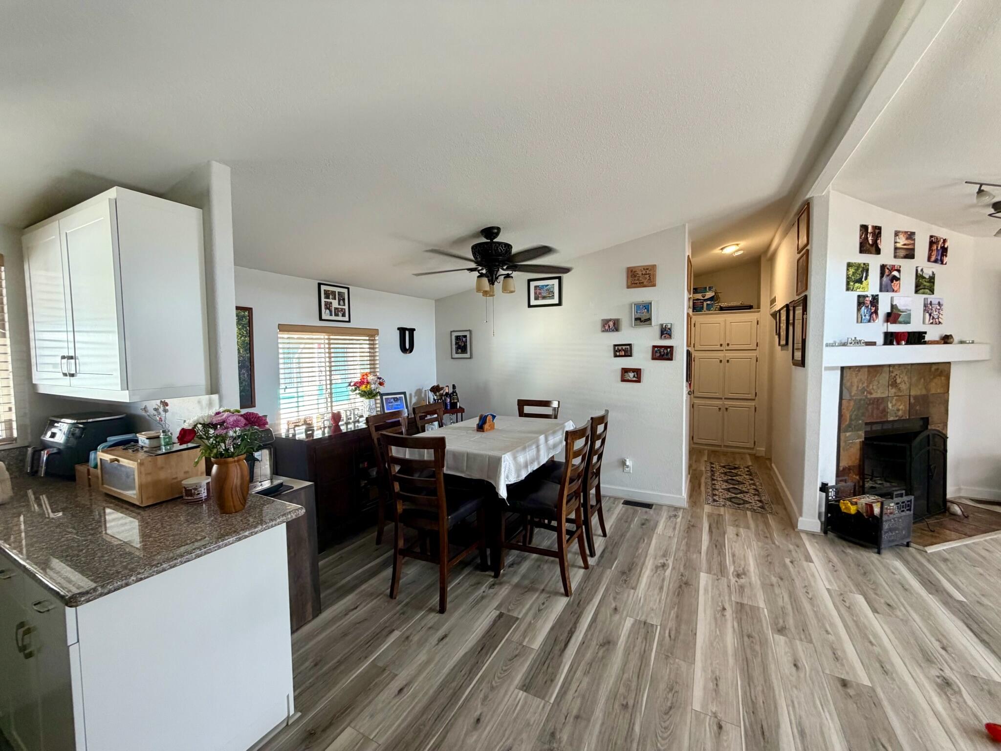 9080 Bloomfield Street, Unit 270 Cypress, CA 90630 - Photo 12 of 34 a view of a dining room with furniture and wooden floor