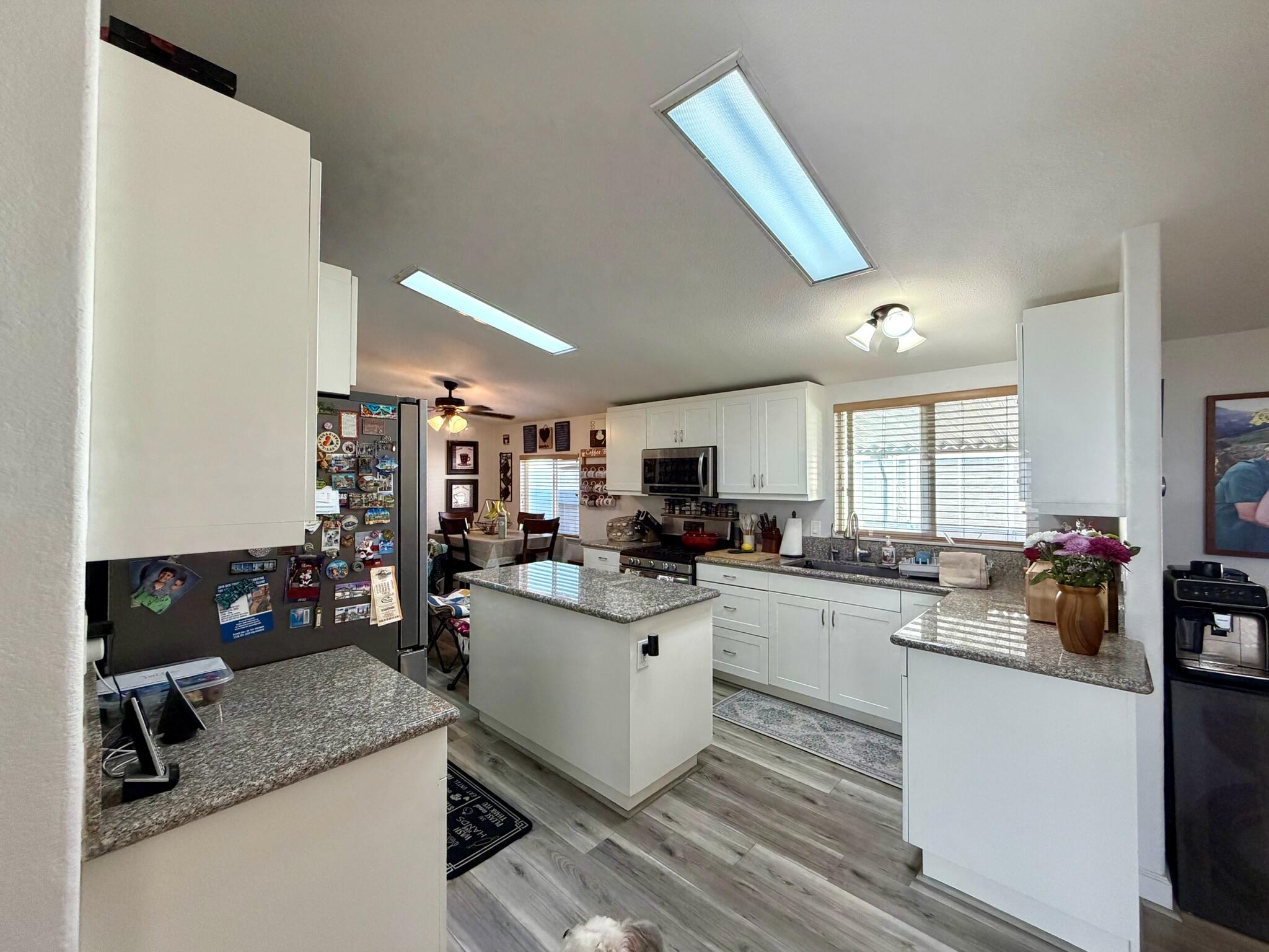 9080 Bloomfield Street, Unit 270 Cypress, CA 90630 - Photo 16 of 34 a kitchen with a sink a counter top space cabinets and stainless steel appliances