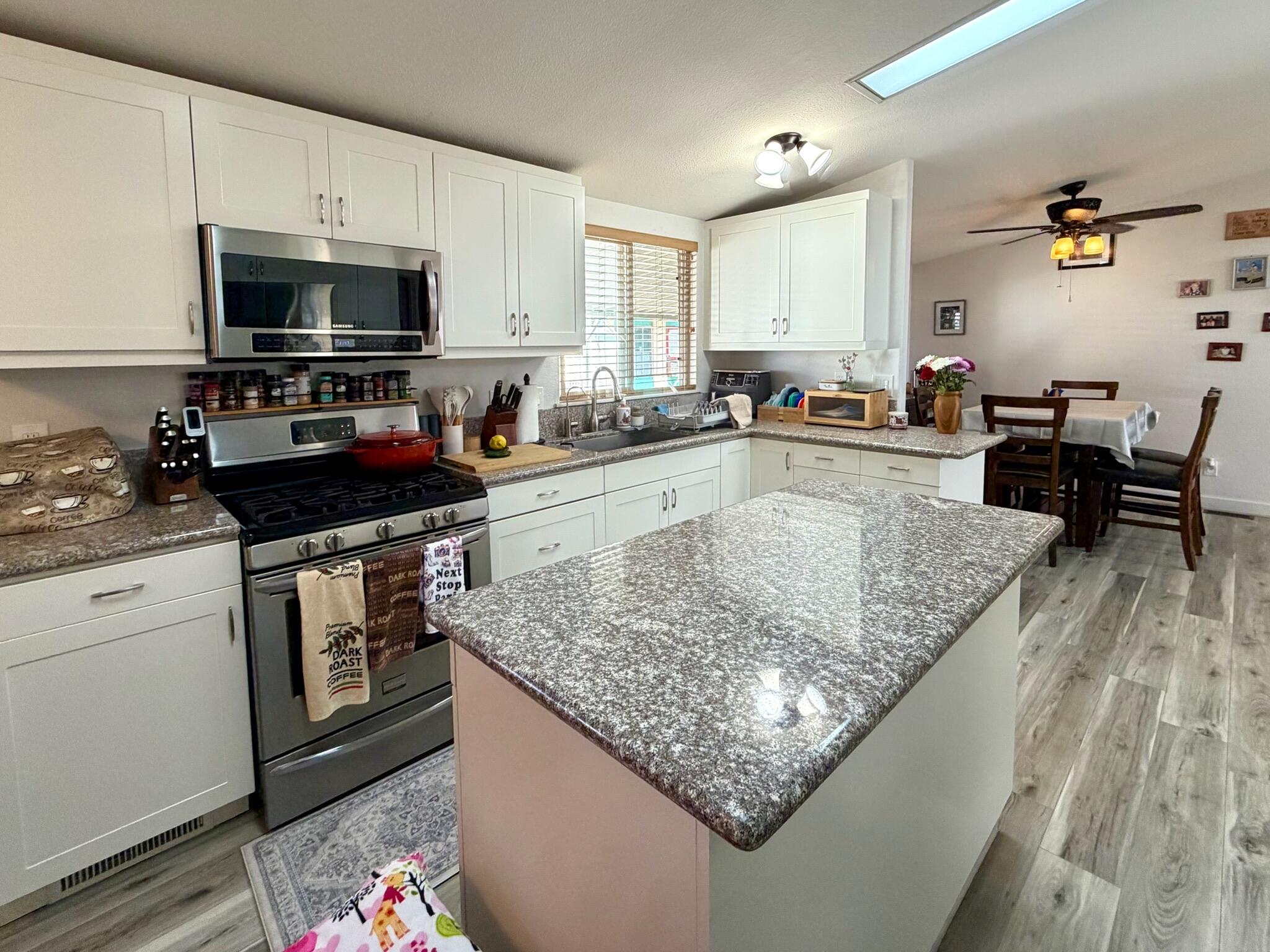 9080 Bloomfield Street, Unit 270 Cypress, CA 90630 - Photo 17 of 34 a kitchen with stainless steel appliances granite countertop a stove oven and a sink