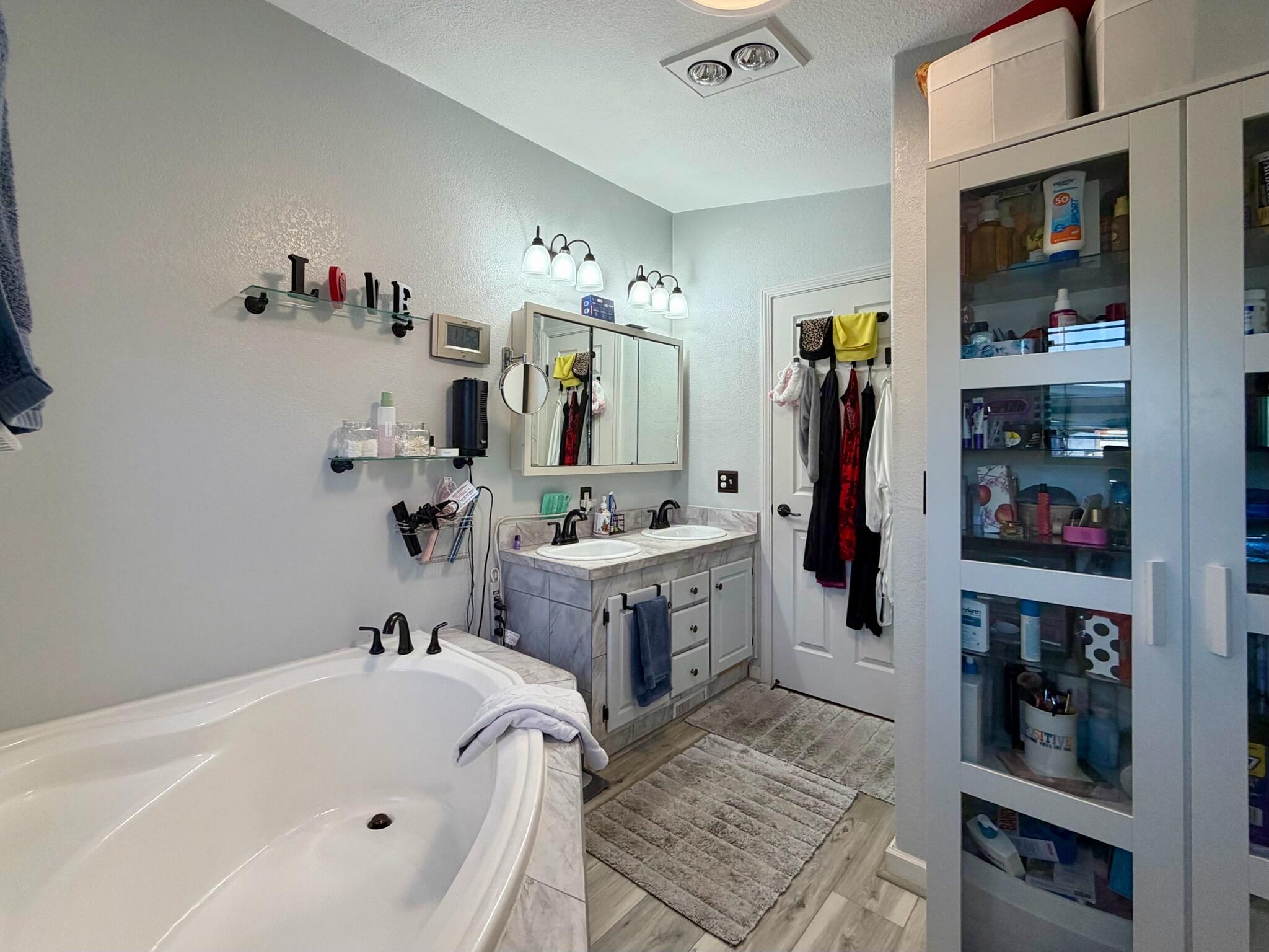 9080 Bloomfield Street, Unit 270 Cypress, CA 90630 - Photo 21 of 34 a bathroom with a tub sink and mirror