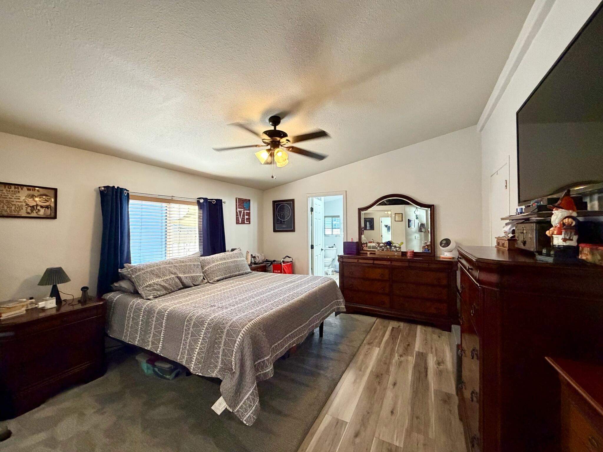 9080 Bloomfield Street, Unit 270 Cypress, CA 90630 - Photo 23 of 34 a bedroom with a bed and a dresser with wooden floor