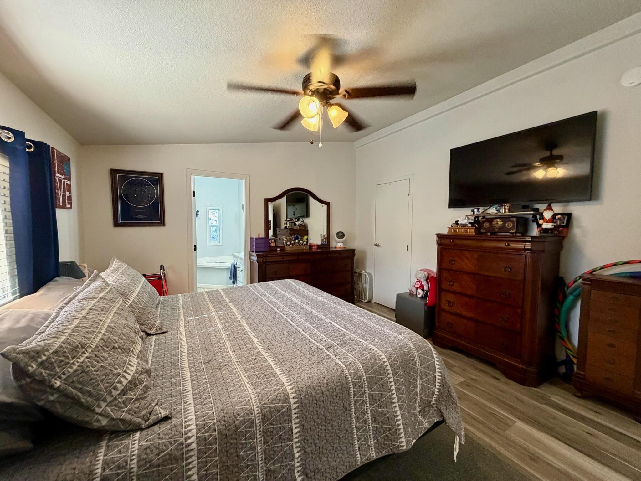 9080 Bloomfield Street, Unit 270 Cypress, CA 90630 - Photo 24 of 34 a bedroom with a bed and a flat screen tv