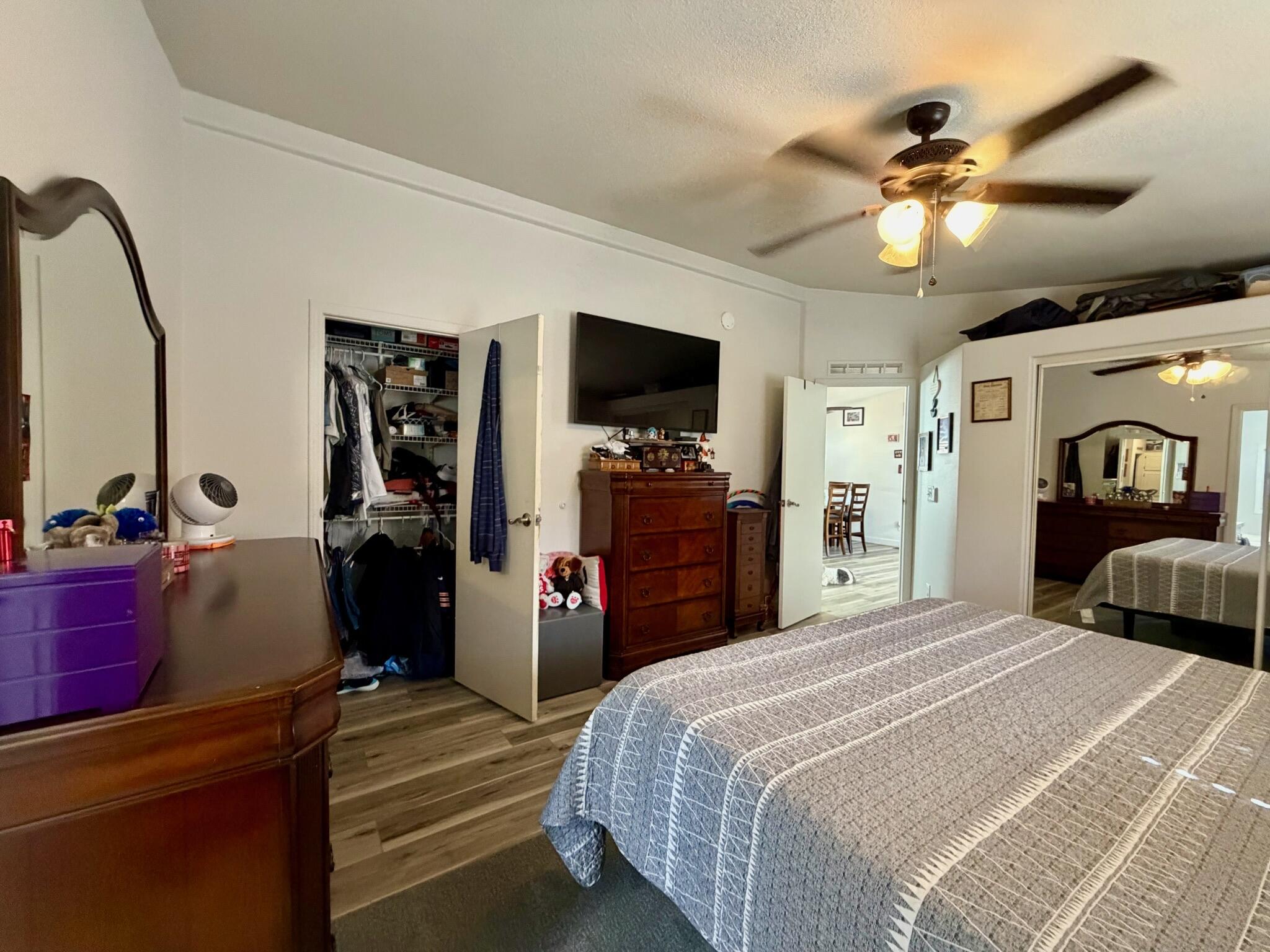 9080 Bloomfield Street, Unit 270 Cypress, CA 90630 - Photo 25 of 34 a bedroom with bed tv and a mirror