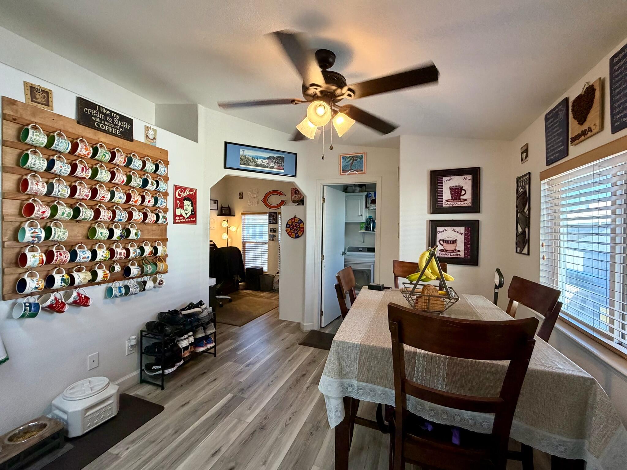 9080 Bloomfield Street, Unit 270 Cypress, CA 90630 - Photo 27 of 34 a dining room with wooden floor furniture and a chandelier