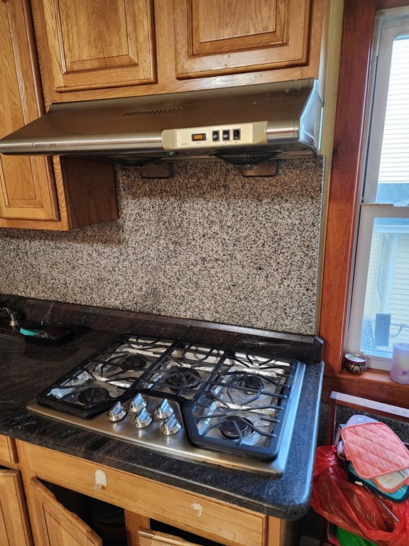 2 Thayer Street Worcester, MA 01603 - Photo 12 of 33 a close view of a stove a microwave and cabinets