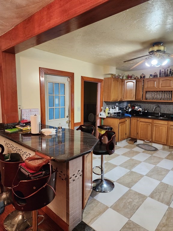 2 Thayer Street Worcester, MA 01603 - Photo 14 of 33 a kitchen with a sink a stove and chairs