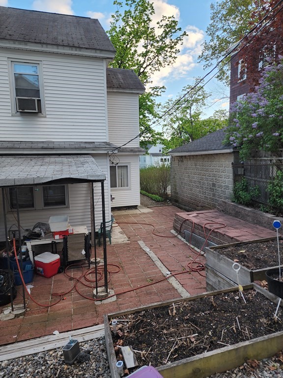 2 Thayer Street Worcester, MA 01603 - Photo 30 of 33 a backyard of a house with barbeque oven table and chairs
