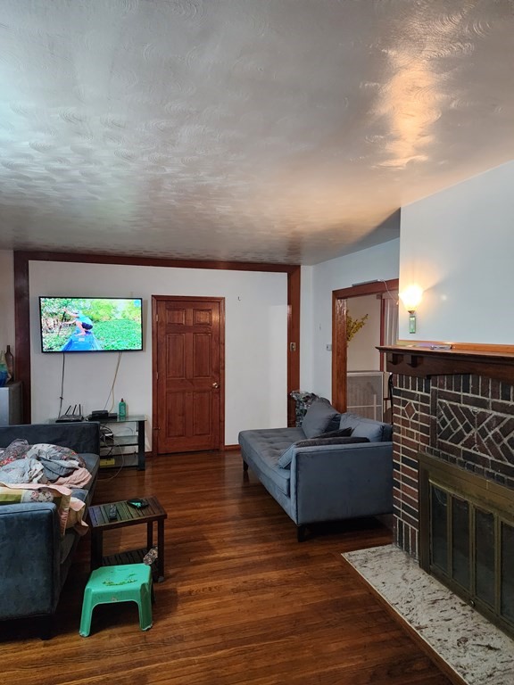 2 Thayer Street Worcester, MA 01603 - Photo 5 of 33 a living room with furniture and a fireplace