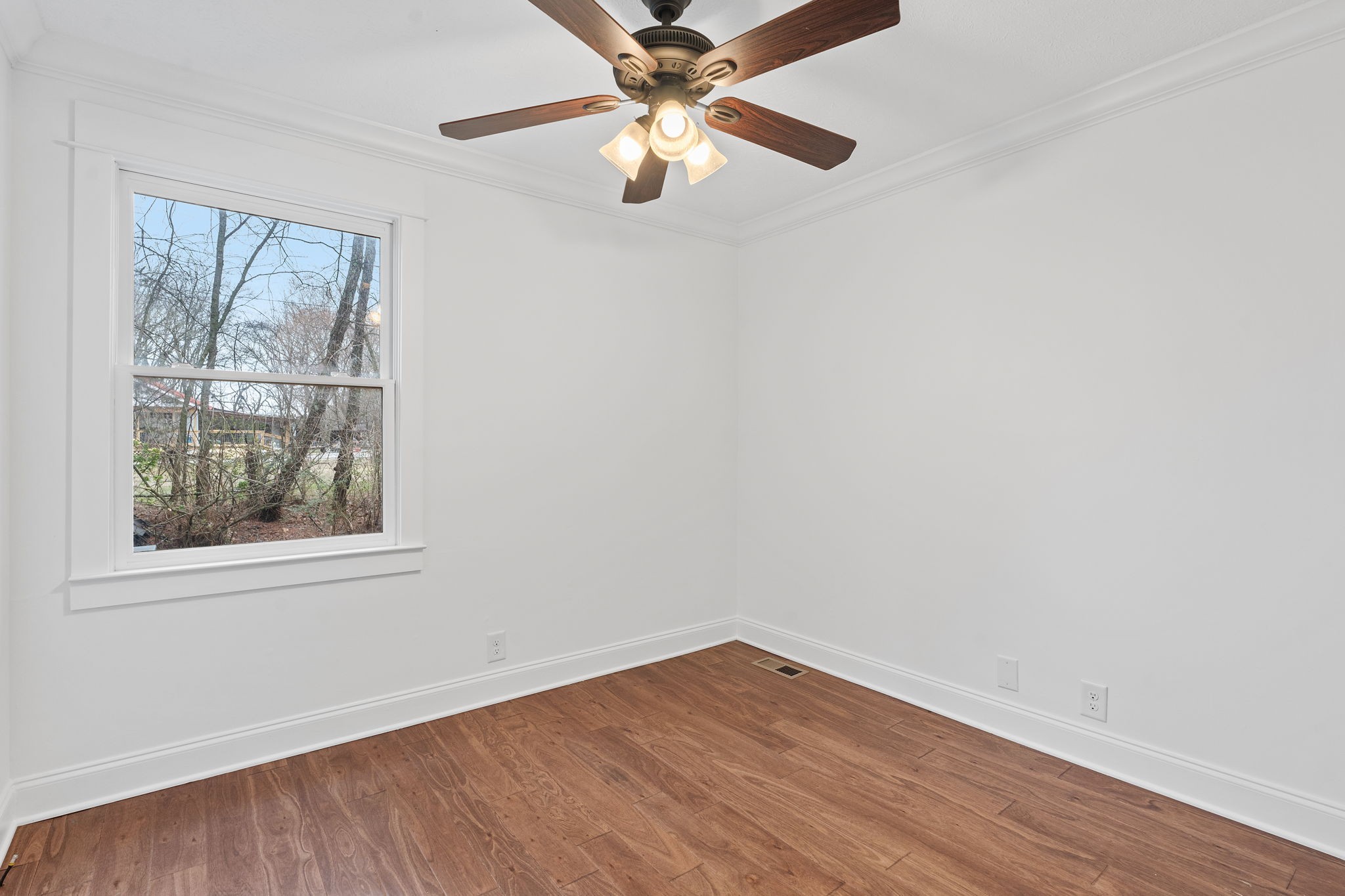 4462 Harpeth School Road Franklin, TN 37064 - Photo 31 of 45 an empty room with wooden floor fan and windows