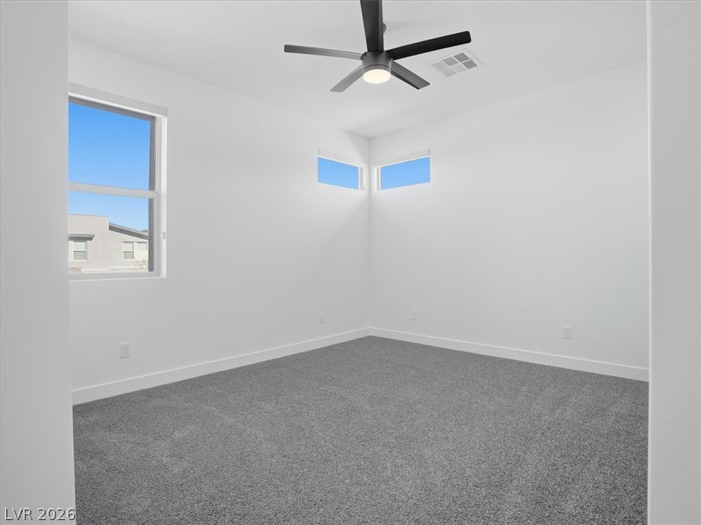 9725 Starlight Ridge Avenue Las Vegas, NV 89148 - Photo 31 of 47 This bright bedroom features ample natural light and plush carpeting, creating a serene personal retreat.