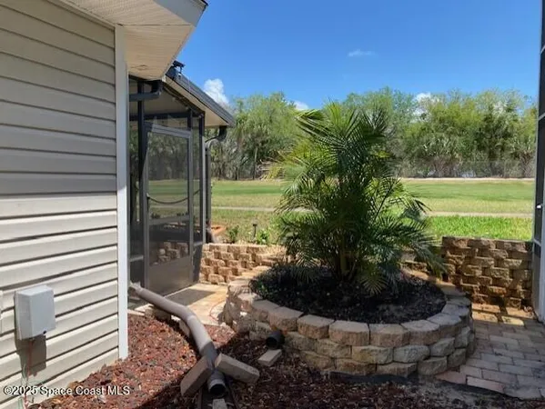 a view of a house with backyard and sitting area