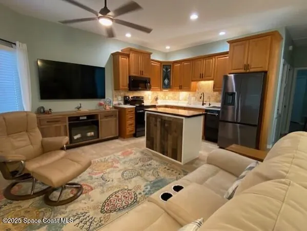 a kitchen with stainless steel appliances granite countertop a refrigerator stove and microwave