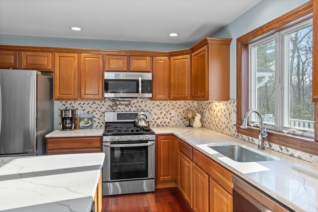 277 Sawyer Road Bolton, MA 01740 - Photo 15 of 41 a kitchen with stainless steel appliances a stove sink microwave and refrigerator