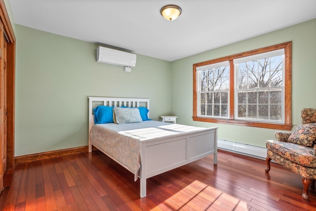 277 Sawyer Road Bolton, MA 01740 - Photo 26 of 41 a bedroom with a bed and wooden floor