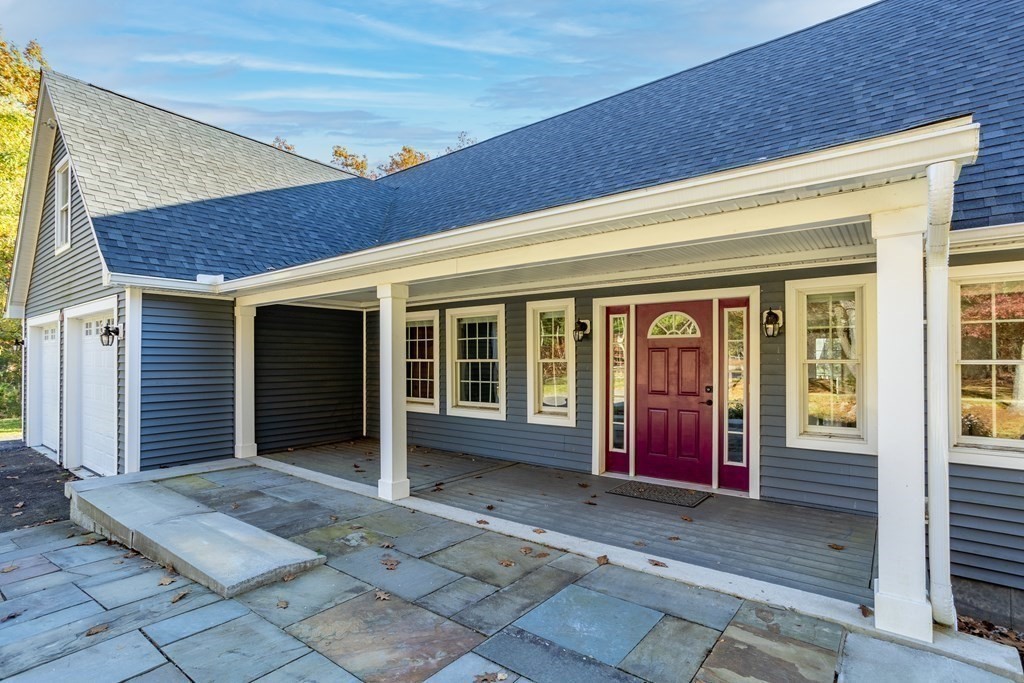 277 Sawyer Road Bolton, MA 01740 - Photo 3 of 41 a view of a house with large windows and plants