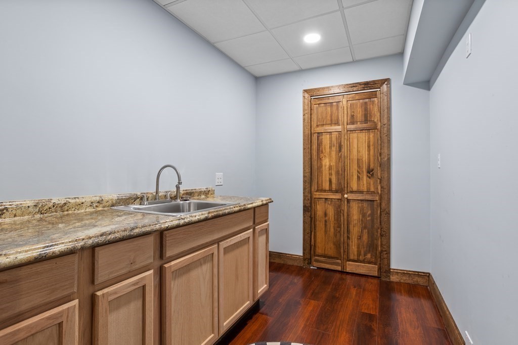 277 Sawyer Road Bolton, MA 01740 - Photo 31 of 41 a kitchen with sink a refrigerator and wooden floor