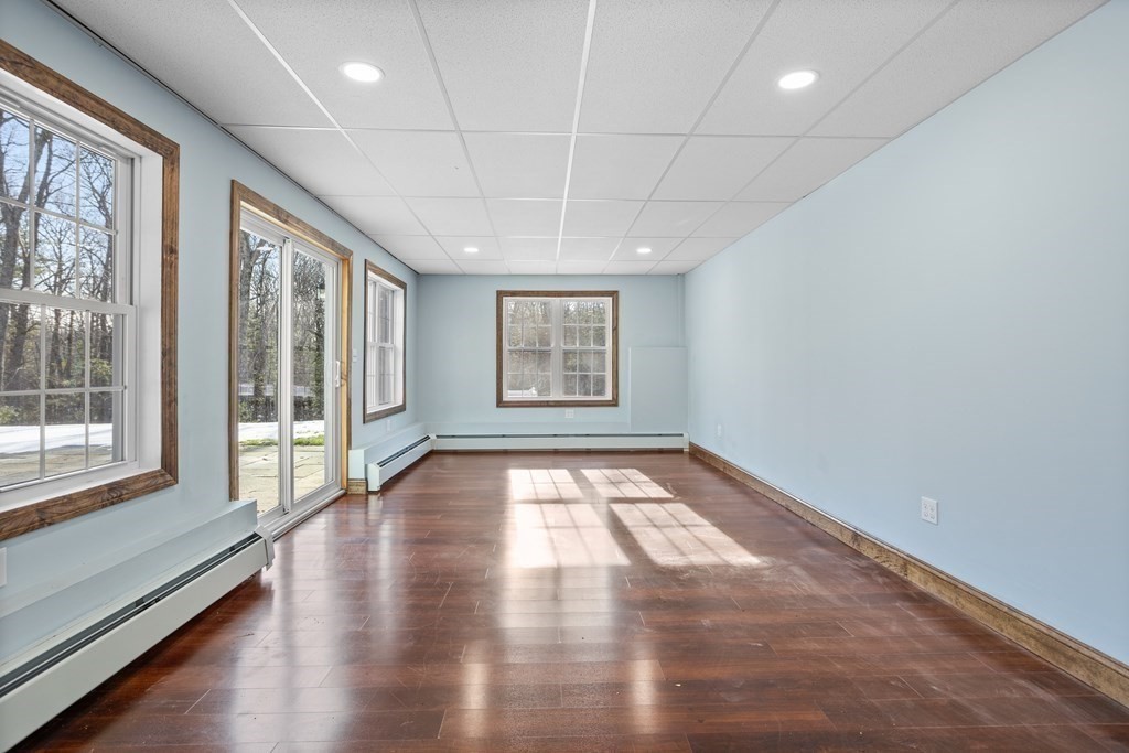 277 Sawyer Road Bolton, MA 01740 - Photo 33 of 41 an empty room with wooden floor and windows