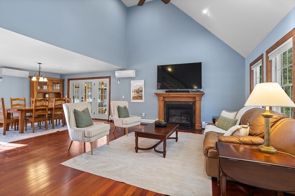 277 Sawyer Road Bolton, MA 01740 - Photo 4 of 41 a living room with furniture a fireplace and a flat screen tv