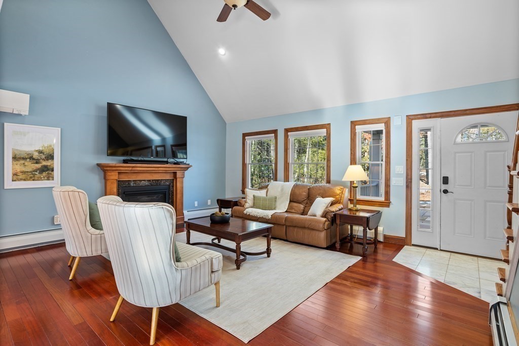 277 Sawyer Road Bolton, MA 01740 - Photo 5 of 41 a living room with fireplace furniture and a flat screen tv