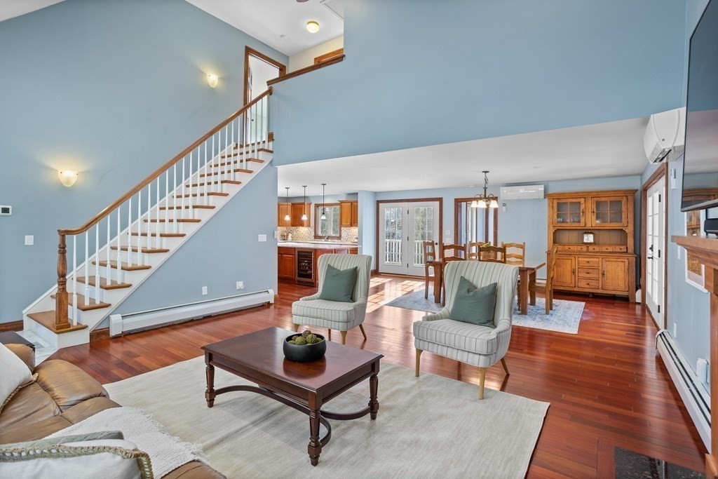 277 Sawyer Road Bolton, MA 01740 - Photo 7 of 41 a living room with furniture and a wooden floor
