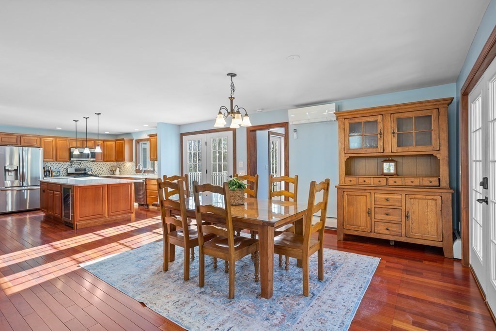 277 Sawyer Road Bolton, MA 01740 - Photo 9 of 41 a view of a dining room with furniture and wooden floor