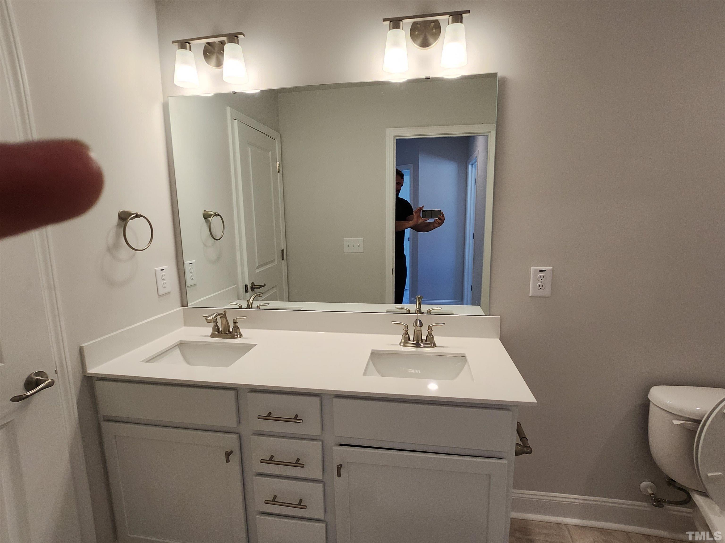243 Spring Flowers Drive Cameron, NC 28326 - Photo 12 of 30 a bathroom with a sink and a mirror