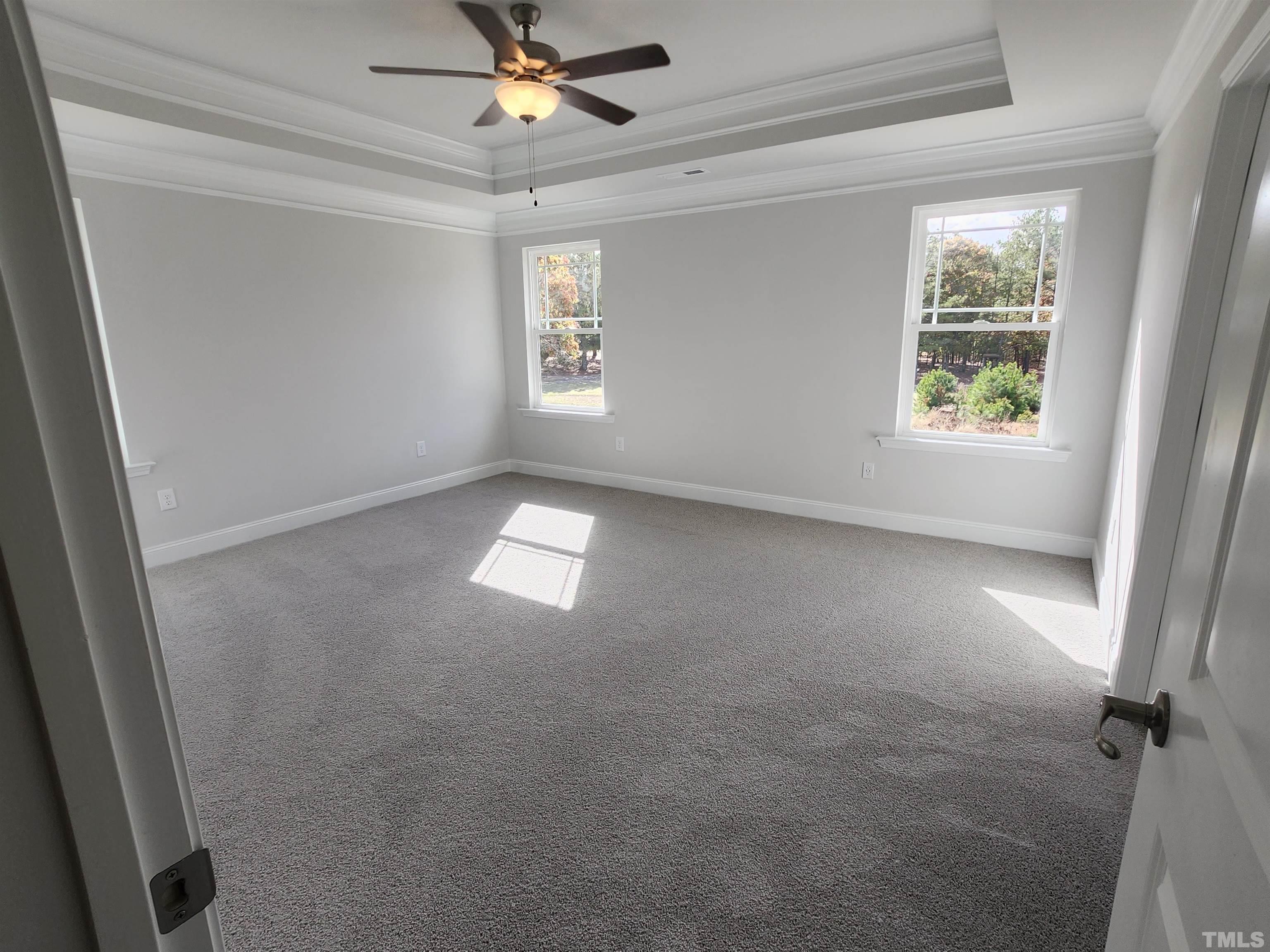 243 Spring Flowers Drive Cameron, NC 28326 - Photo 13 of 30 an empty room with windows and fan