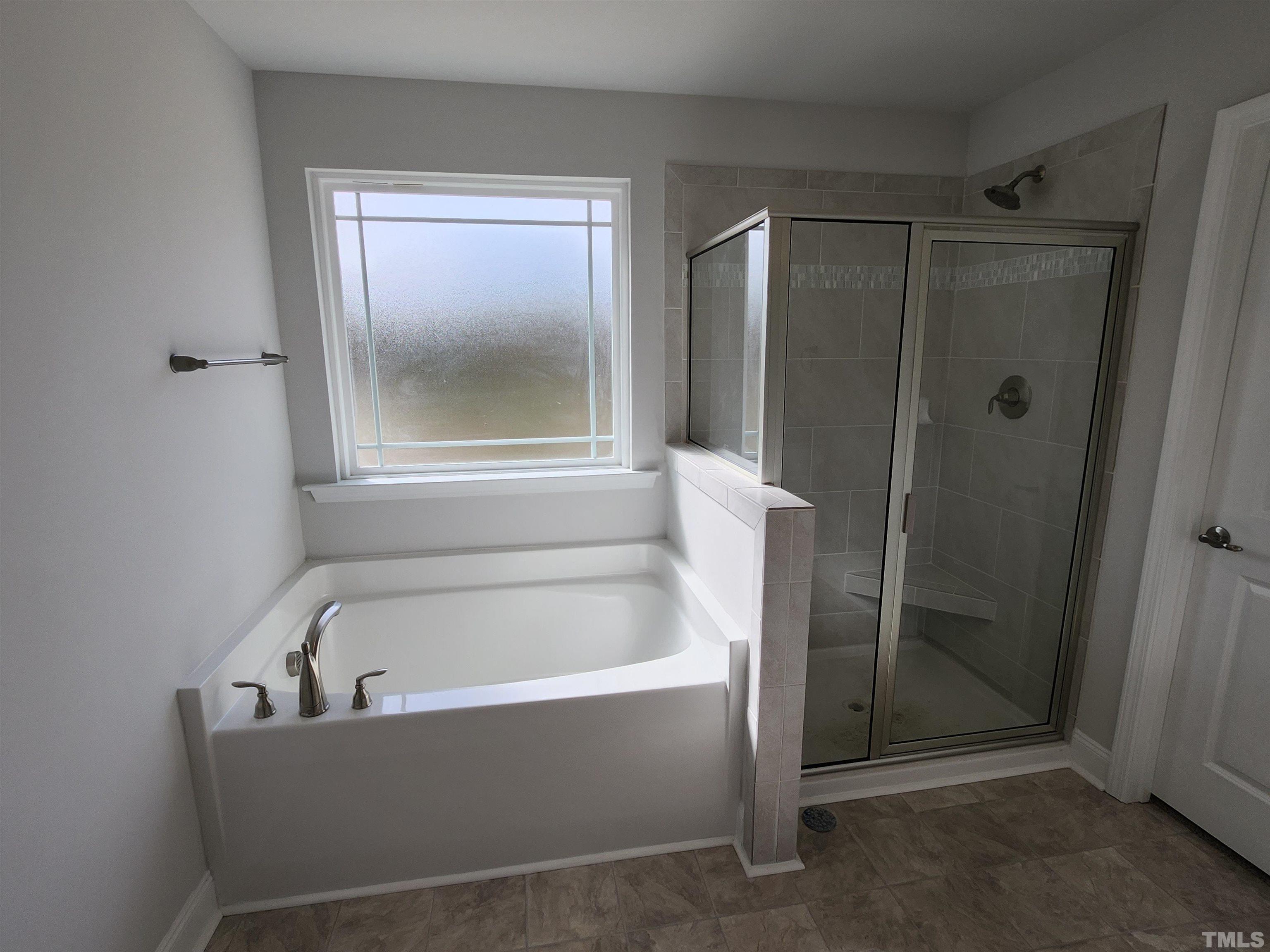 243 Spring Flowers Drive Cameron, NC 28326 - Photo 15 of 30 a bathroom with a bathtub and a shower
