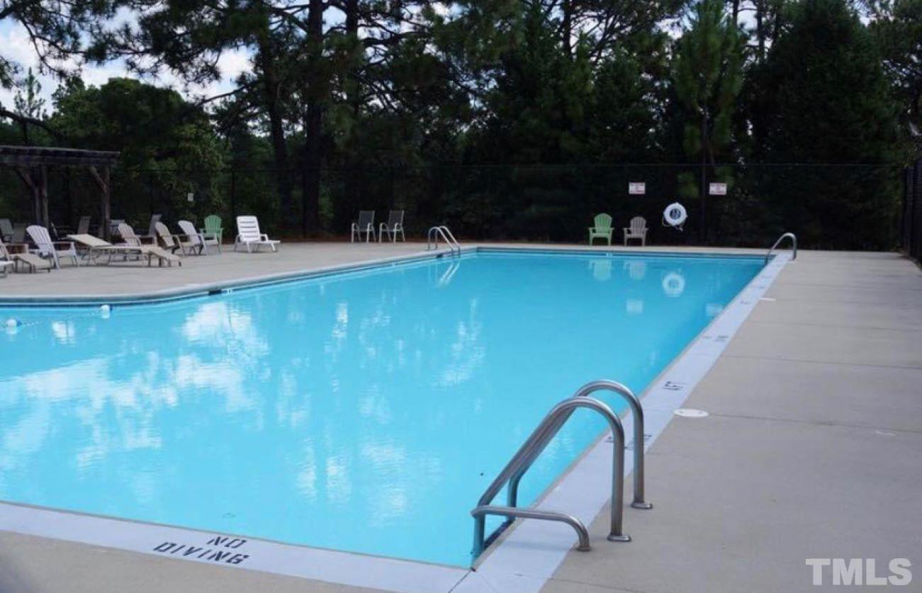 243 Spring Flowers Drive Cameron, NC 28326 - Photo 28 of 30 a view of swimming pool with a bench and trees