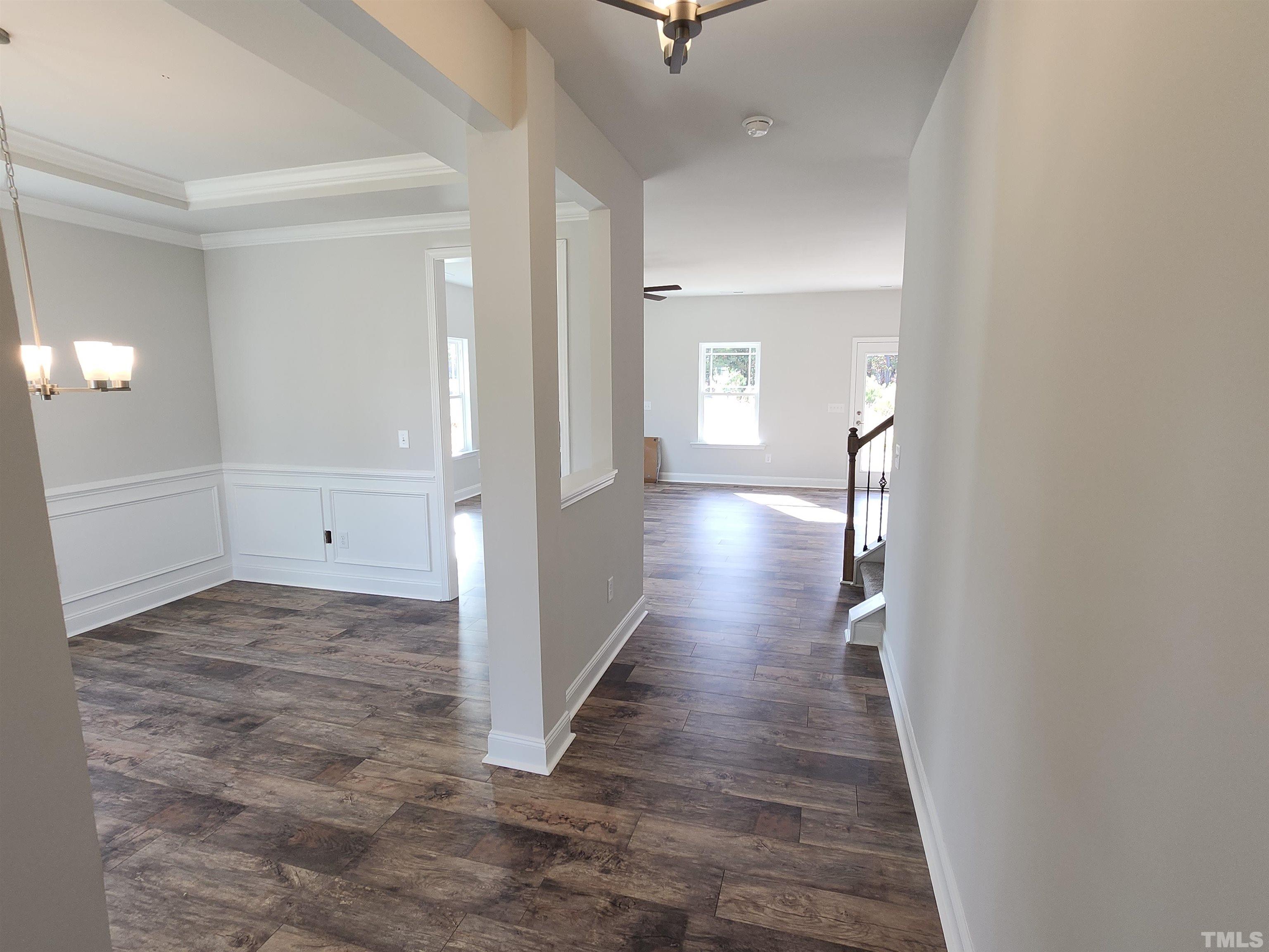 243 Spring Flowers Drive Cameron, NC 28326 - Photo 3 of 30 a view of a hallway with wooden floor