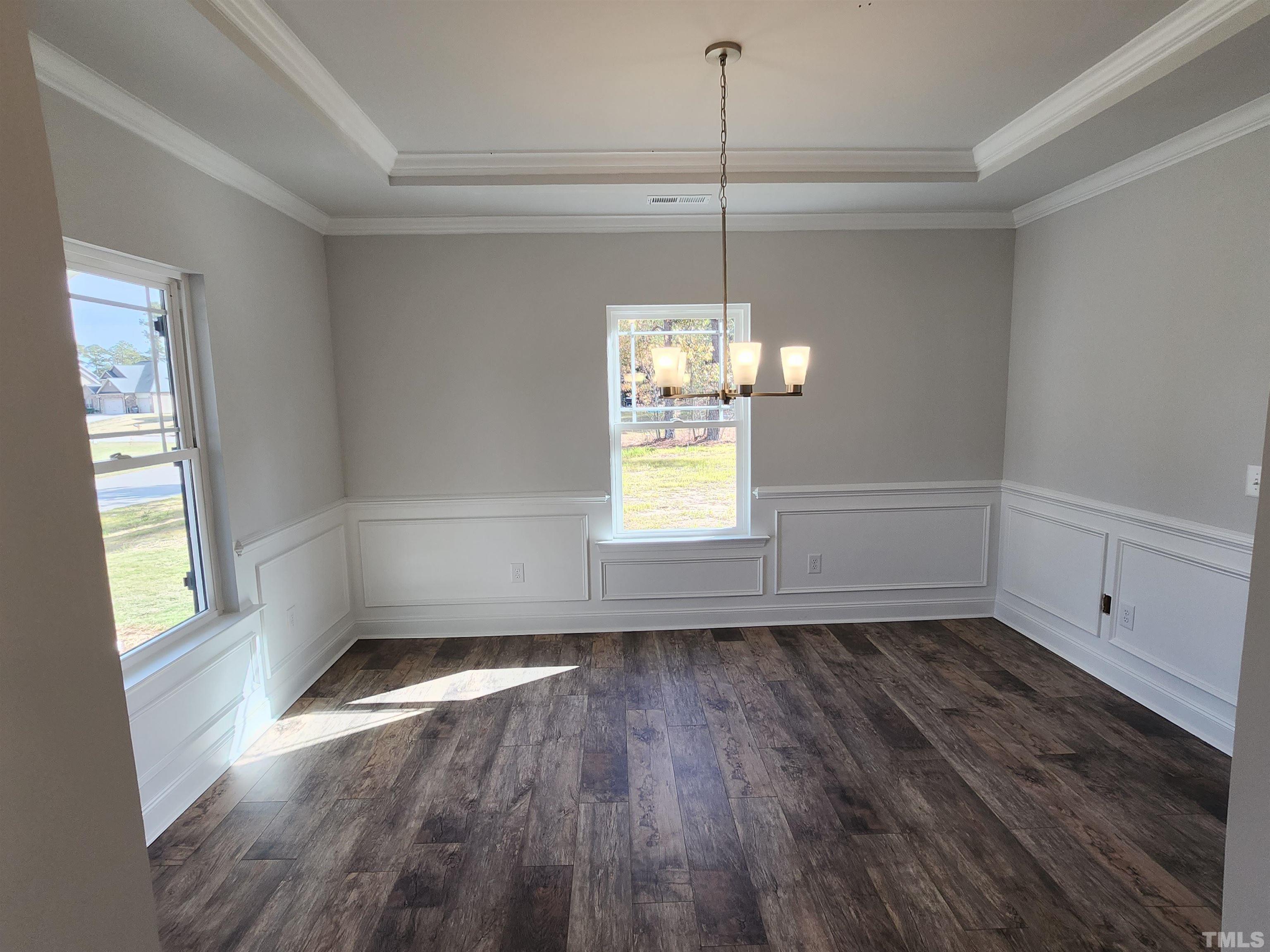 243 Spring Flowers Drive Cameron, NC 28326 - Photo 4 of 30 a view of an empty room with wooden floor and a window